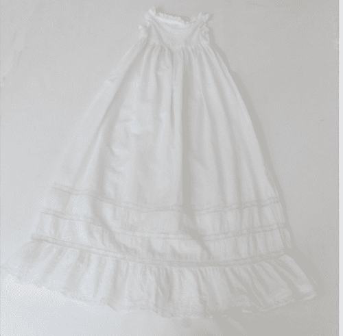 White historic child’s dress after cleaning.